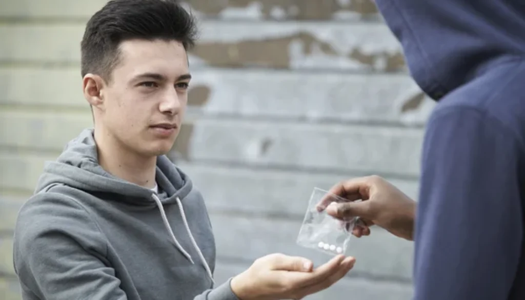 depositphotos_53459093-stock-photo-teenage-boy-buying-drugs-on